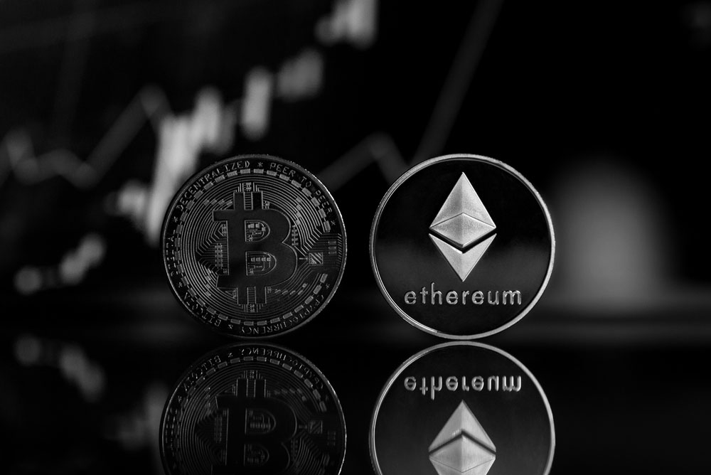 Etherum and Bitcoin coins standing image used for thomas stray financial alchemy